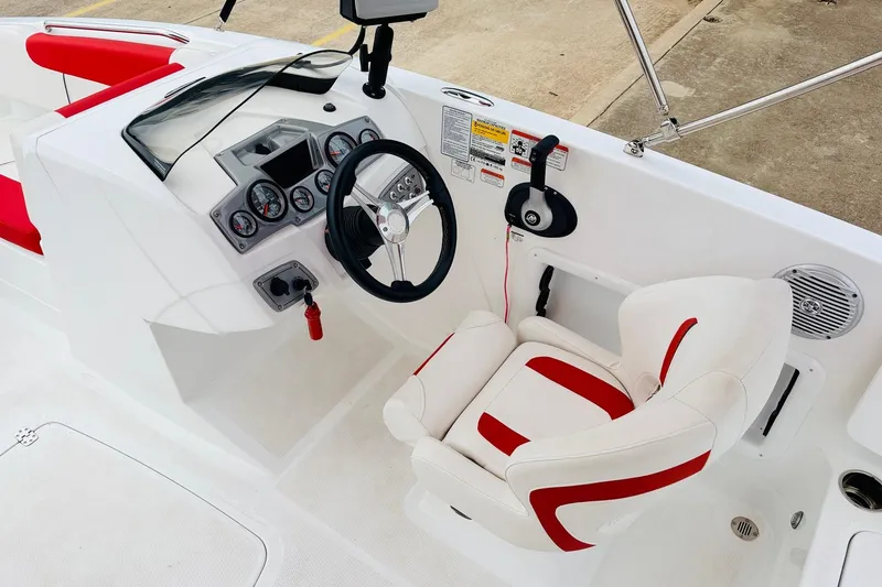 Slide: The Image of Cockpit of 2021 Tahoe 1950 boat with steering wheel and red-accented seating. - 35