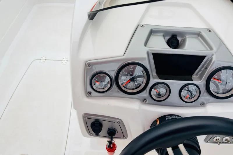 Slide: The Image of Dashboard of a 2021 Tahoe 1950 boat with gauges and controls. - 37