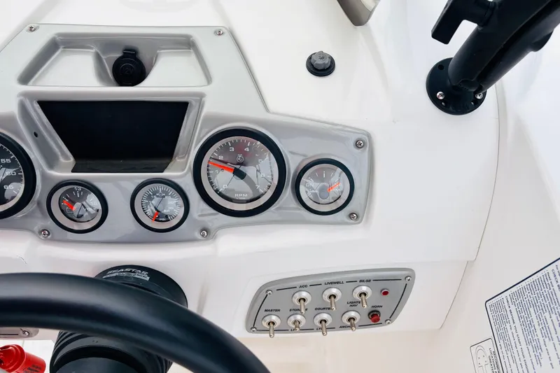 Slide: The Image of Dashboard of a 2021 Tahoe 1950 boat with gauges and switches. - 38