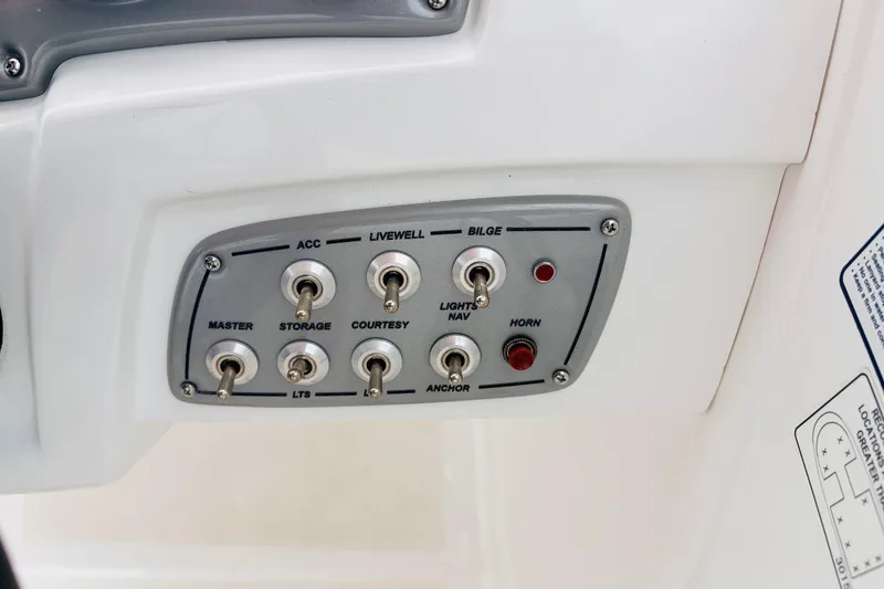 Slide: The Image of Control panel of a 2021 Tahoe 1950 boat with labeled switches. - 39