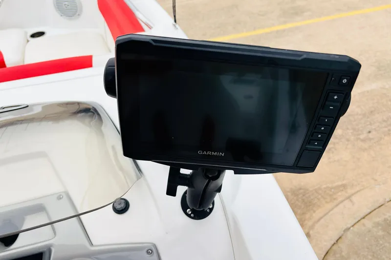 Slide: The Image of Garmin device on 2021 Tahoe 1950 boat dashboard with red and white seating. - 40