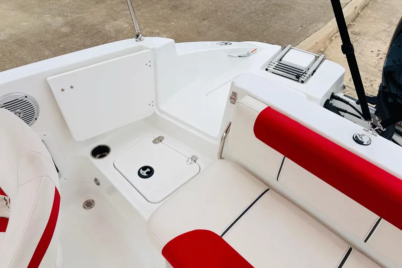 Slide: The Image of 2021 Tahoe 1950 boat interior with red and white seating, storage compartments, and cup holders. - 41