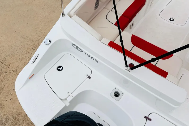 Slide: The Image of 2021 Tahoe 1950 boat interior with red and white seating, viewed from above. - 43