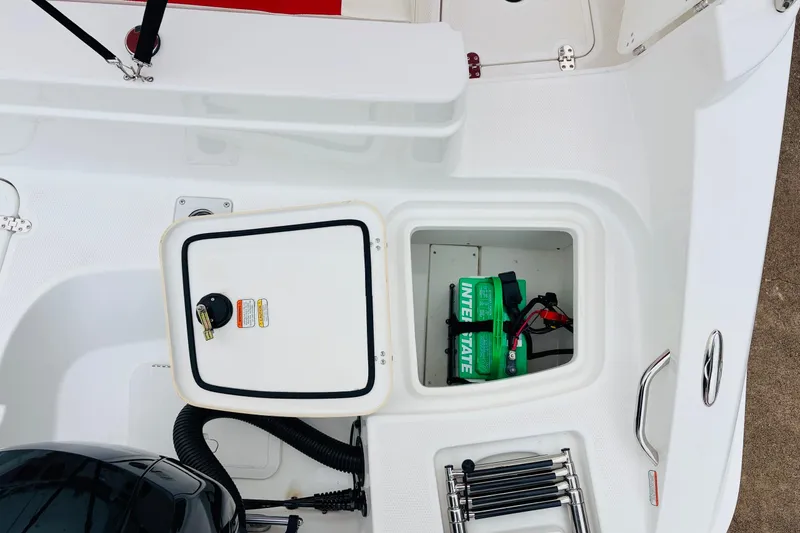 Slide: The Image of Interior view of a 2021 Tahoe 1950 boat showing storage compartments and battery. - 47