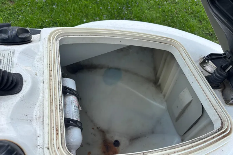 Slide: The Image of Open storage compartment of a 2002 Sea-Doo GTX DI, showing interior and fire extinguisher. - 5