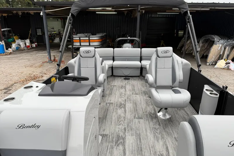 Slide: The Image of 2026 Bentley Pontoons Legacy 243 Navigator interior with gray seating and modern design. - 11