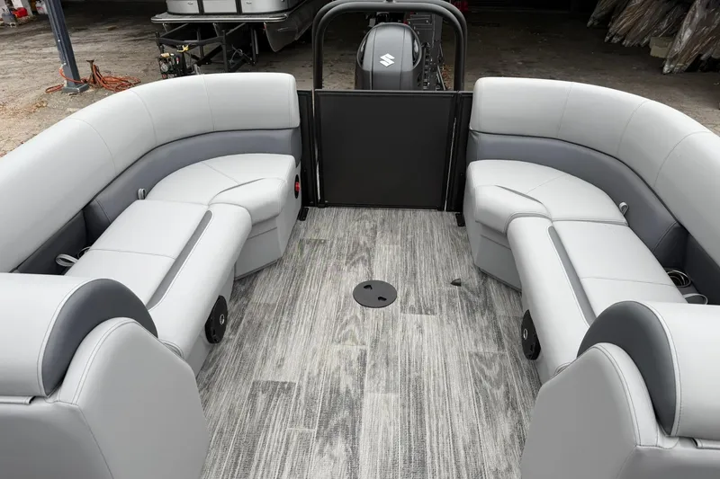 Slide: The Image of 2026 Bentley Pontoons Legacy 243 Navigator interior with gray seating and wood-style flooring. - 13