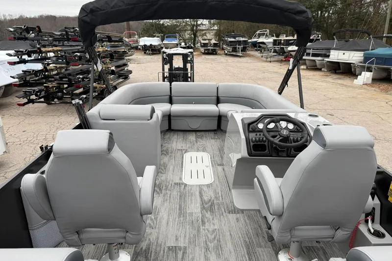 Slide: The Image of 2026 Bentley Pontoons Legacy 243 Navigator interior with gray seating and modern dashboard. - 15