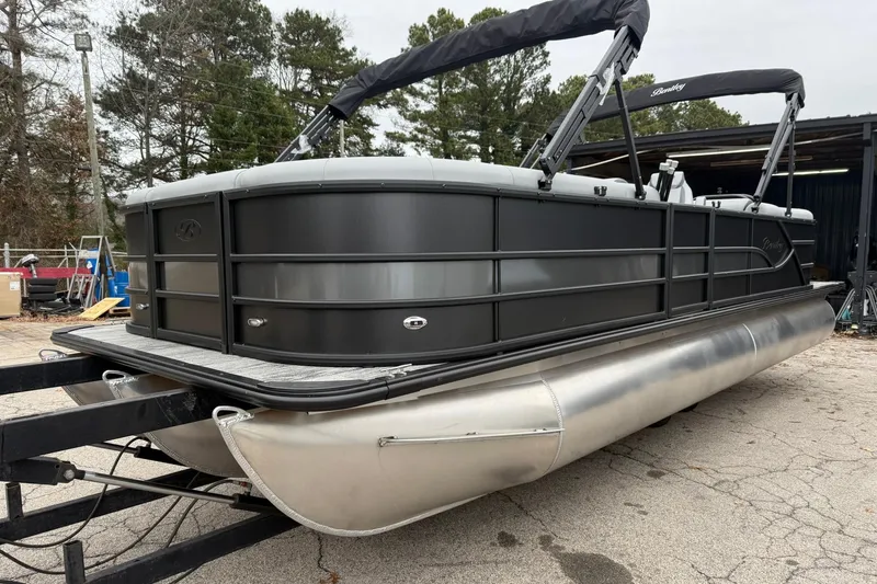 Slide: The Image of 2026 Bentley Pontoons Legacy 243 Navigator on trailer, sleek design, outdoor setting. - 18