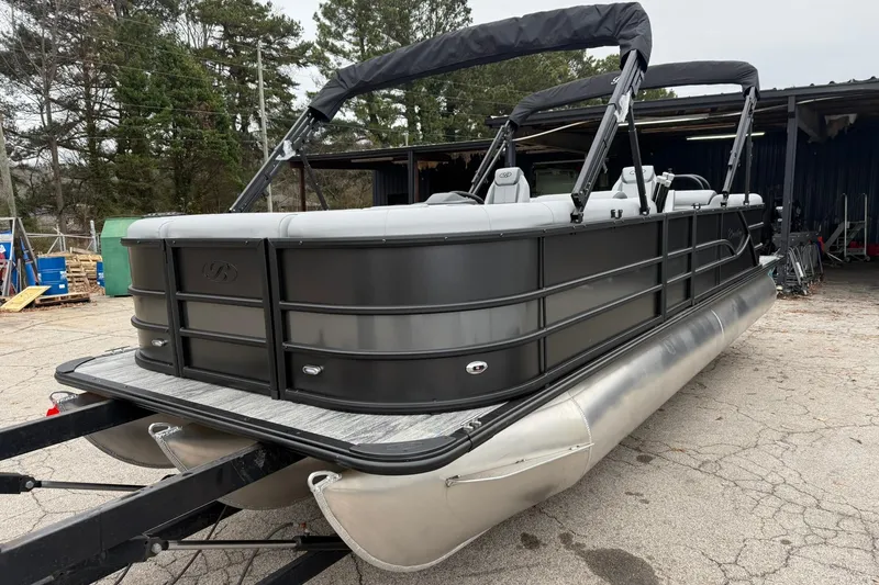 Slide: The Image of 2026 Bentley Pontoons Legacy 243 Navigator, sleek design, parked outdoors. - 2