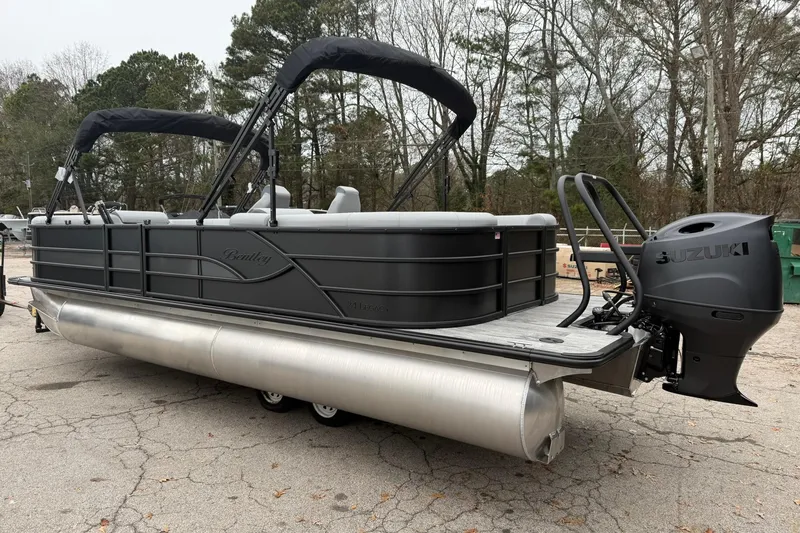 Slide: The Image of 2026 Bentley Pontoons Legacy 243 Navigator with Suzuki engine, parked outdoors. - 3