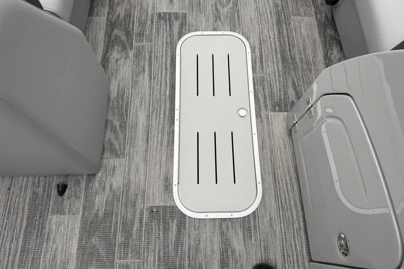 Slide: The Image of 2026 Bentley Pontoons Legacy 243 Navigator interior with sleek flooring and storage compartment. - 5