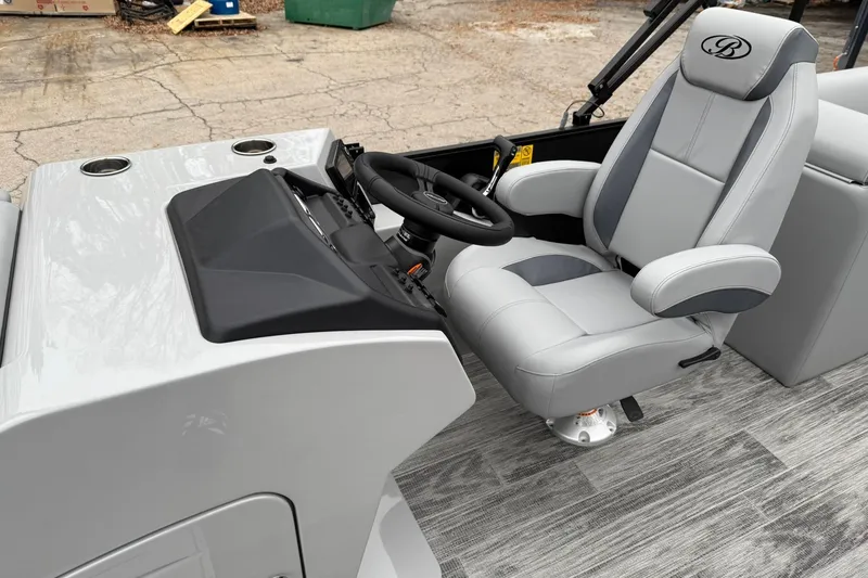 Slide: The Image of 2026 Bentley Pontoons Legacy 243 Navigator helm with luxurious captain's chair and sleek dashboard. - 6