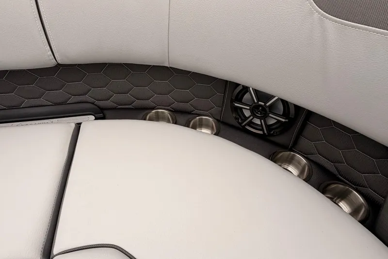 Slide: The Image of 2026 Veranda VR 235 VL boat interior with hexagonal pattern, cup holders, and speaker. - 7