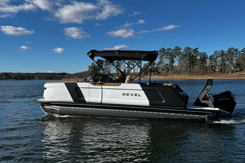 Slide: The Image of 2026 Revel RS25 boat cruising on a lake under a clear blue sky. - 11
