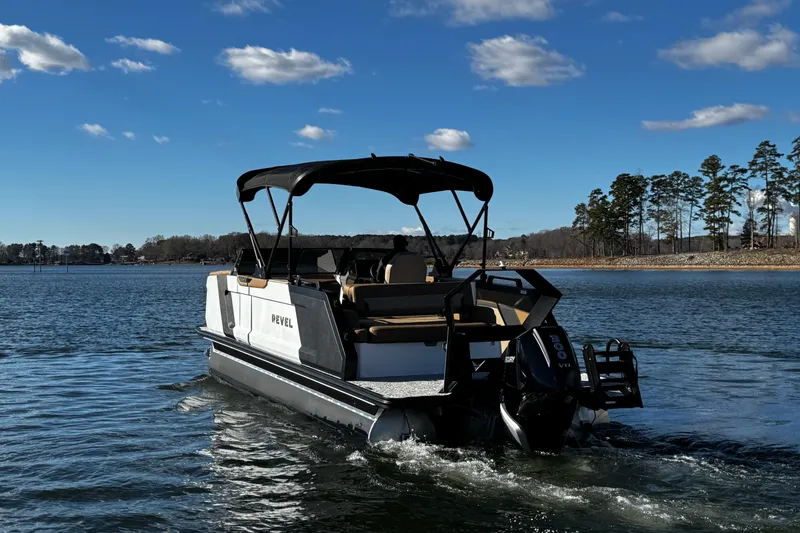 Slide: The Image of 2026 Revel RS25 boat cruising on a lake under a clear blue sky. - 13