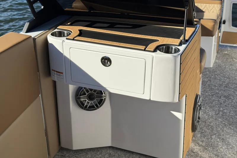 Slide: The Image of 2026 Revel RS25 boat interior with wood accents, cup holders, and speaker system. - 16