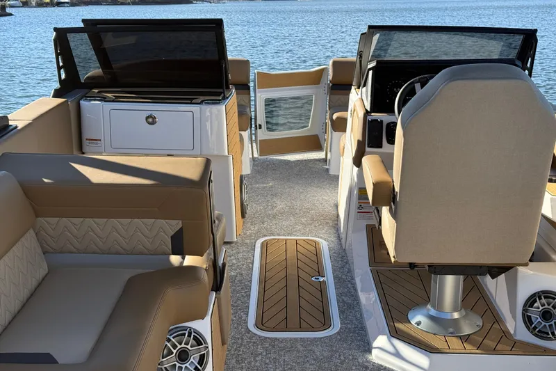 Slide: The Image of Luxurious interior of 2026 Revel RS25 boat with beige seating and modern dashboard. - 24