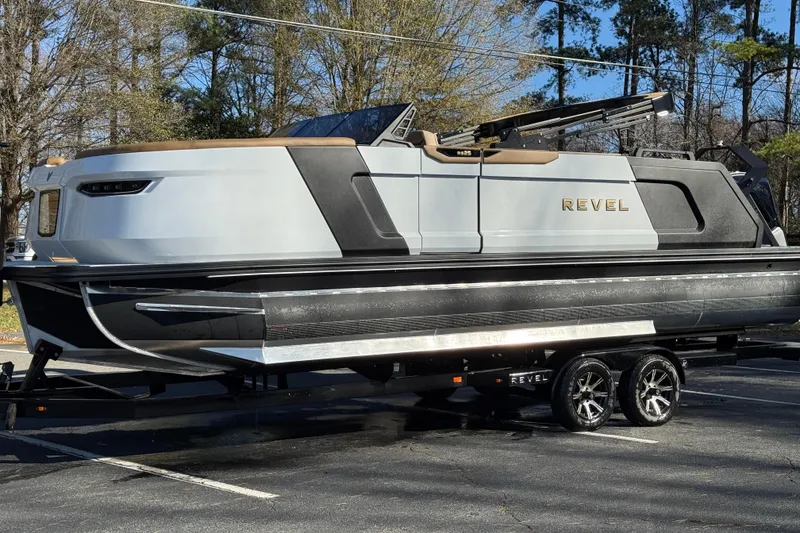 Slide: The Image of 2026 Revel RS25 luxury boat on trailer, parked outdoors, showcasing sleek design and modern features. - 27