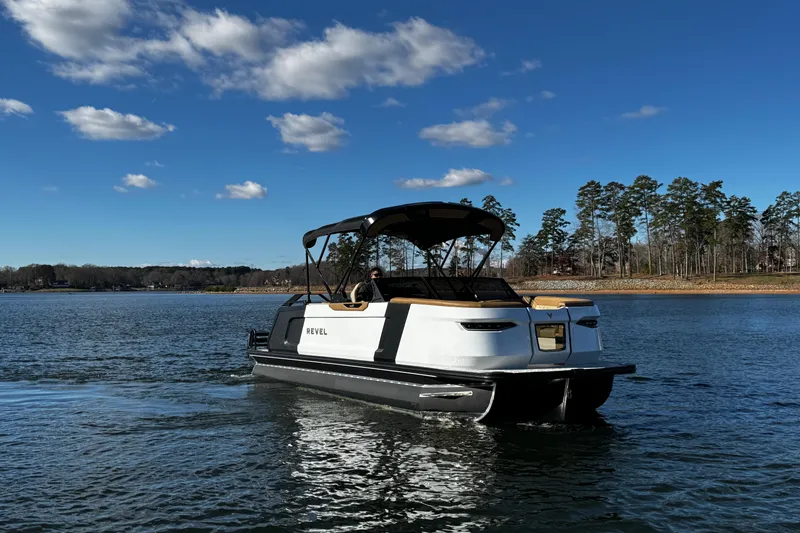 Slide: The Image of 2026 Revel RS25 boat cruising on a serene lake under a clear blue sky. - 3