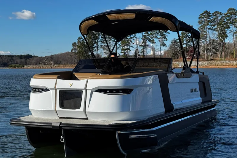 Slide: The Image of 2026 Revel RS25 boat on a lake, featuring sleek design and modern amenities. - 7