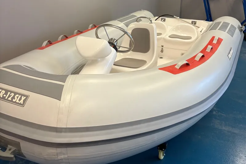 Slide: The Image of 2019 Flexboat SR12 SLX inflatable boat with steering wheel, white and gray design. - 2