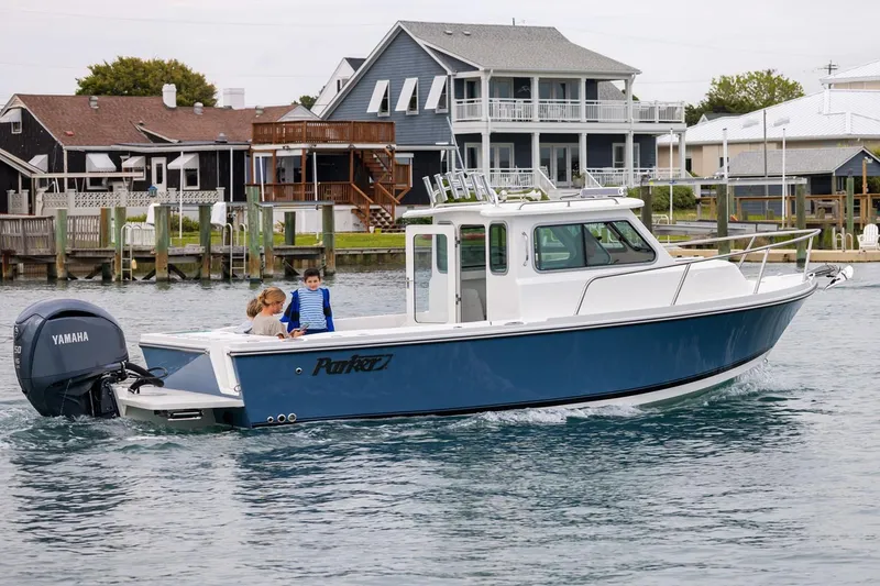 The Image of Manufacturer Provided Image: 2026 Parker 227 Explorer boat cruising near waterfront homes. - 0