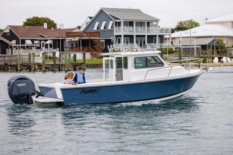 Slide: The Image of 2026 Parker 227 Explorer boat cruising near waterfront homes. - 4