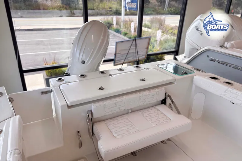 Slide: The Image of 2027 Parker 227 Explorer boat interior with seating and motor, displayed in showroom. - 11