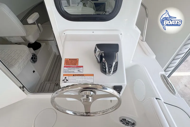 Slide: The Image of Steering console of 2027 Parker 227 Explorer boat with controls and warning labels. - 10