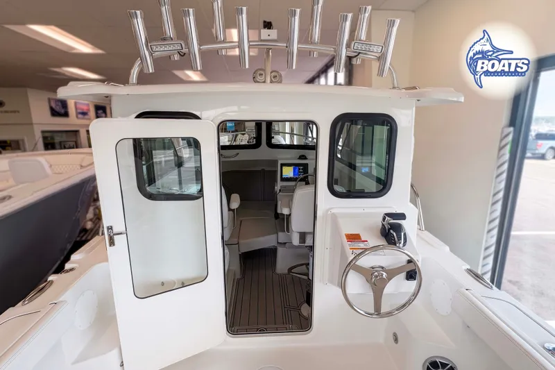 Slide: The Image of 2027 Parker 227 Explorer boat interior with steering wheel and navigation equipment. - 4