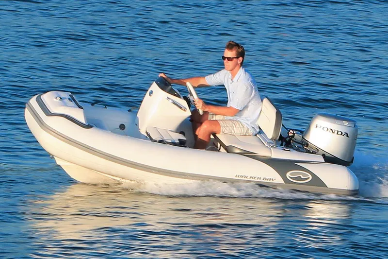 Slide: The Image of Manufacturer Provided Image: Walker Bay Generation 10 LTE 2025 boat cruising on water with Honda engine. - 2