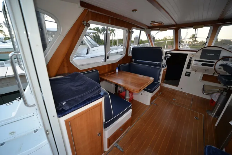 Slide: The Image of Interior of a 2006 True North 38 boat with blue seating and wooden flooring. - 12