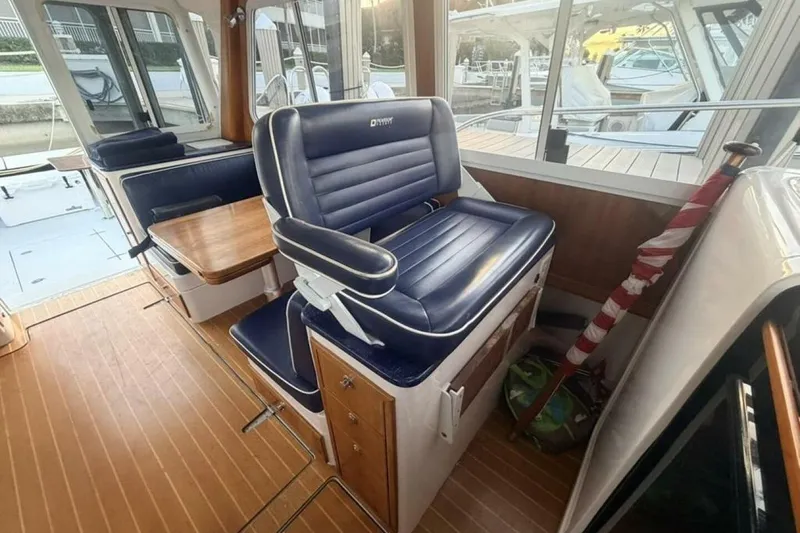 Slide: The Image of Interior of 2006 True North 38 boat with wooden flooring and blue seating. - 13