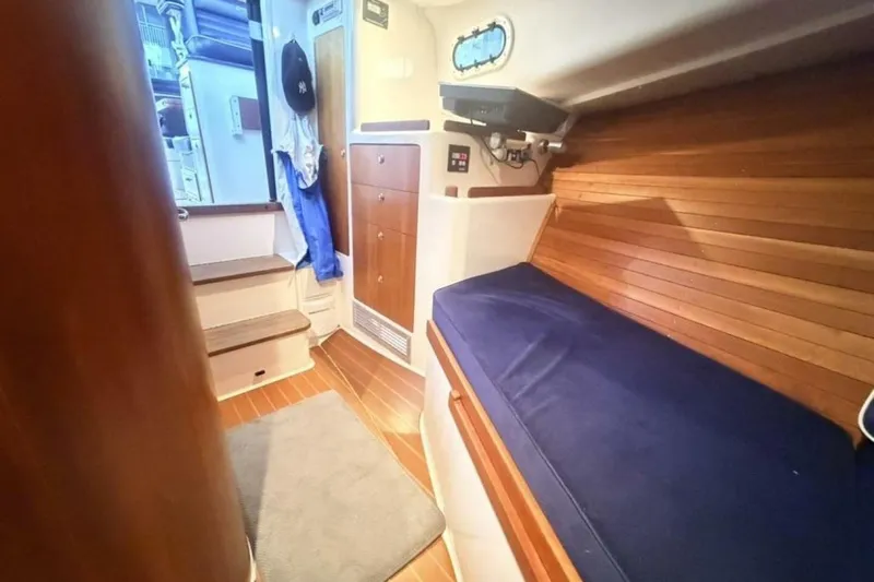 Slide: The Image of Compact bathroom in 2006 True North 38 boat, featuring toilet, sink, and shower. - 16