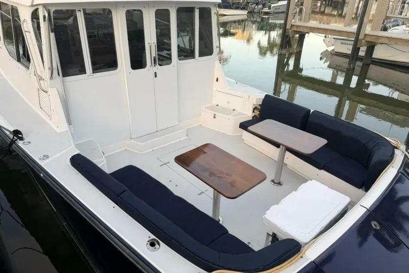 Slide: The Image of 2006 True North 38 yacht docked, featuring a sleek design and spacious deck area. - 19