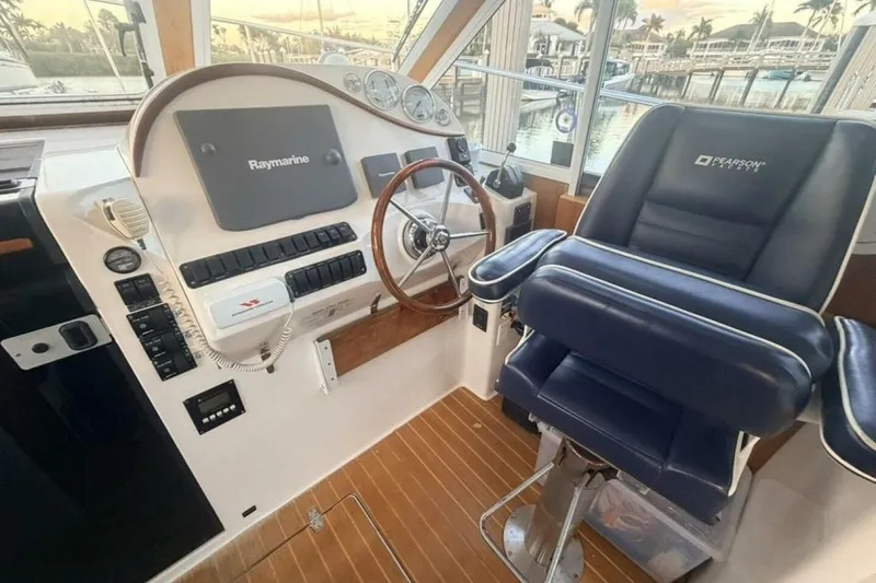 Slide: The Image of Interior of 2006 True North 38 boat with helm, kitchen, and seating area. - 2