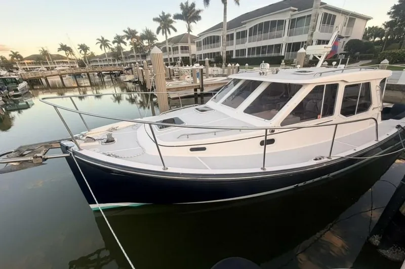 Slide: The Image of True North 38 boat cruising on water, 2006 model, with American flag. - 7