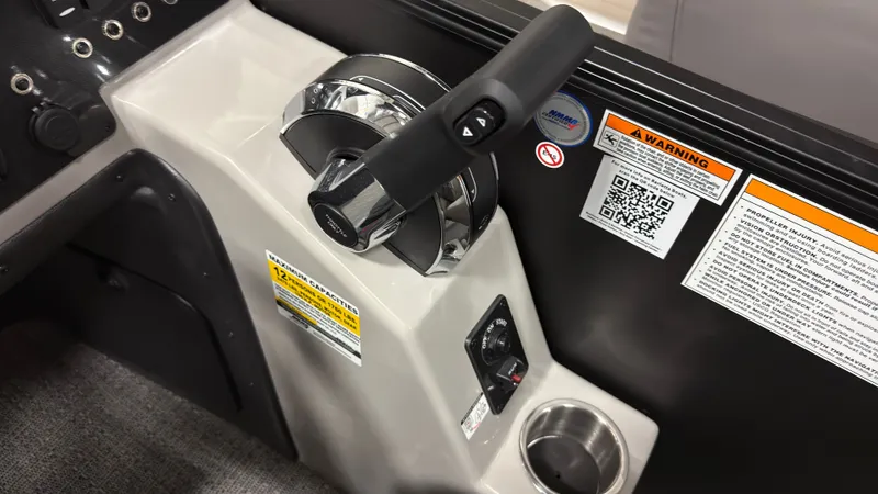 Slide: The Image of Control console of 2026 Barletta SANZA22QC with warning labels and cup holder. - 16