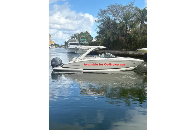 The Image of 2022 Regal 29 OBX boat on water, available for co-brokerage, with scenic background. - 1