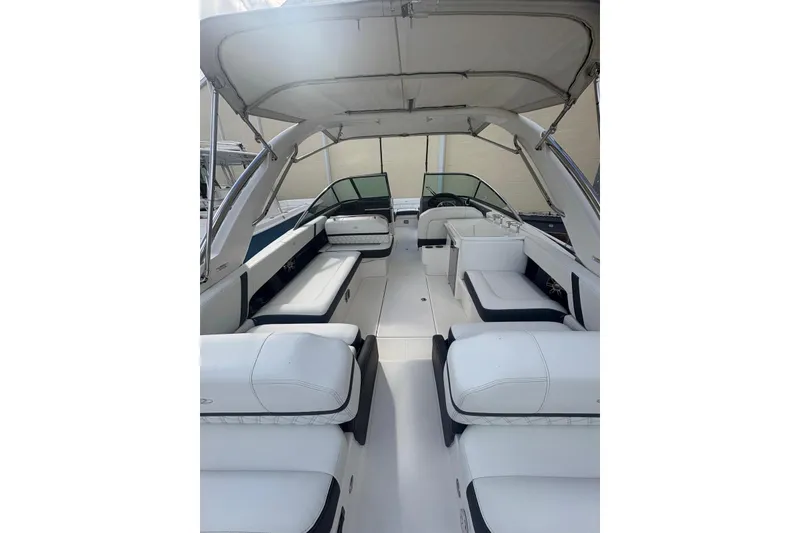 Slide: The Image of 2022 Regal 29 OBX boat interior with spacious seating and canopy. - 10