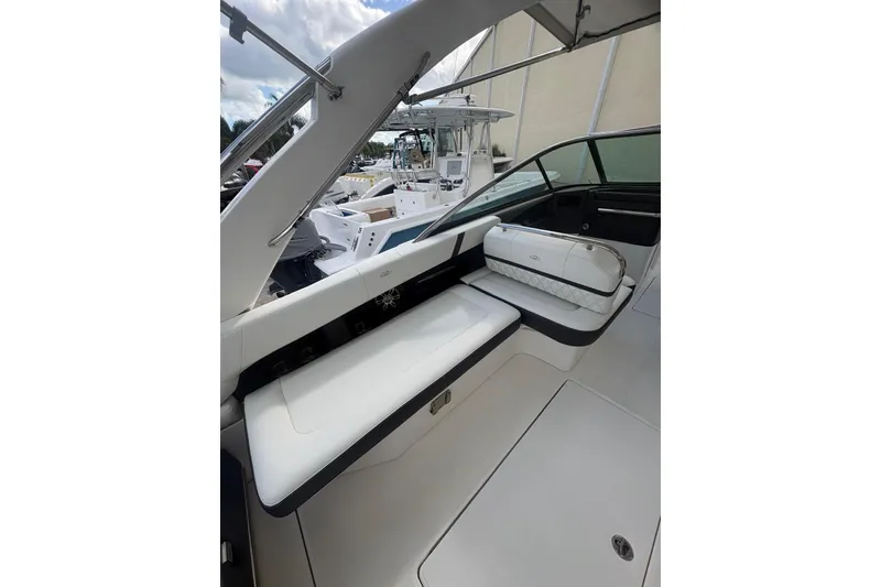 Slide: The Image of 2022 Regal 29 OBX boat interior with white seating and sleek design. - 13