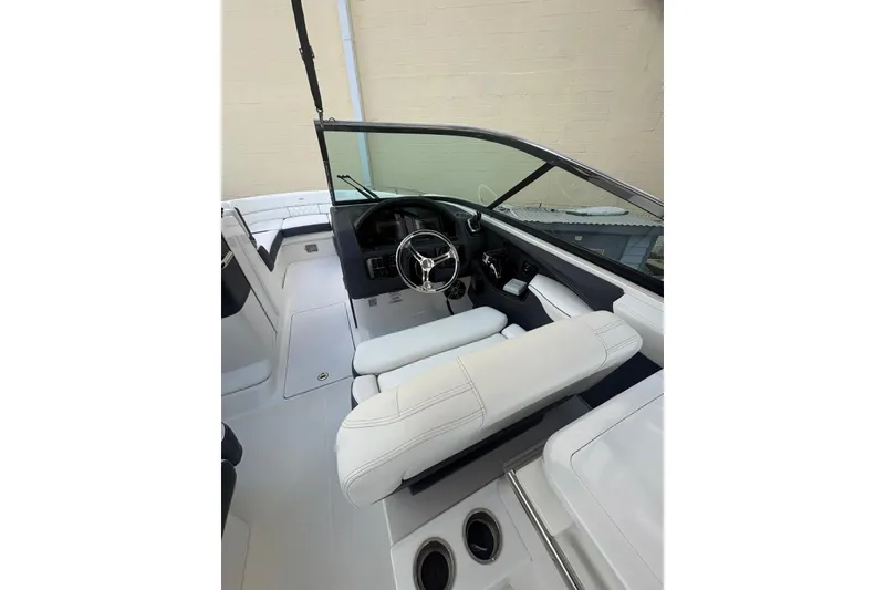 Slide: The Image of 2022 Regal 29 OBX boat interior with white seating and modern dashboard. - 16