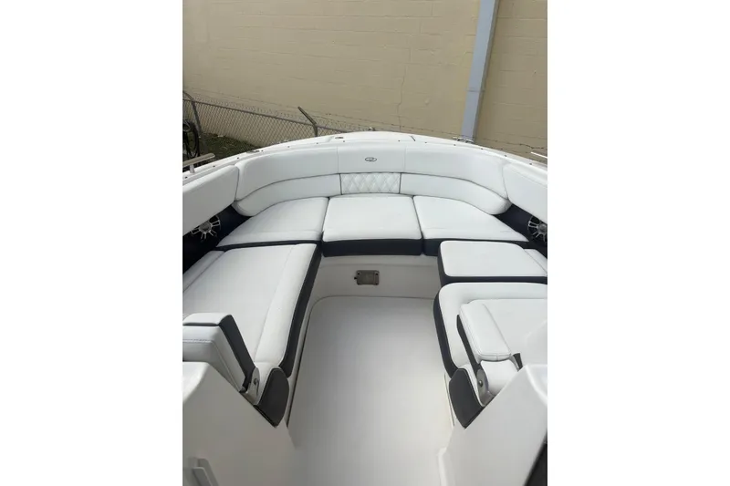 Slide: The Image of 2022 Regal 29 OBX boat interior with white cushioned seating. - 19