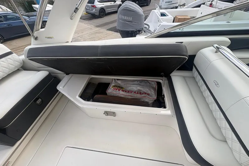 Slide: The Image of 2022 Regal 29 OBX boat interior with open storage compartment and safety gear bag. - 21