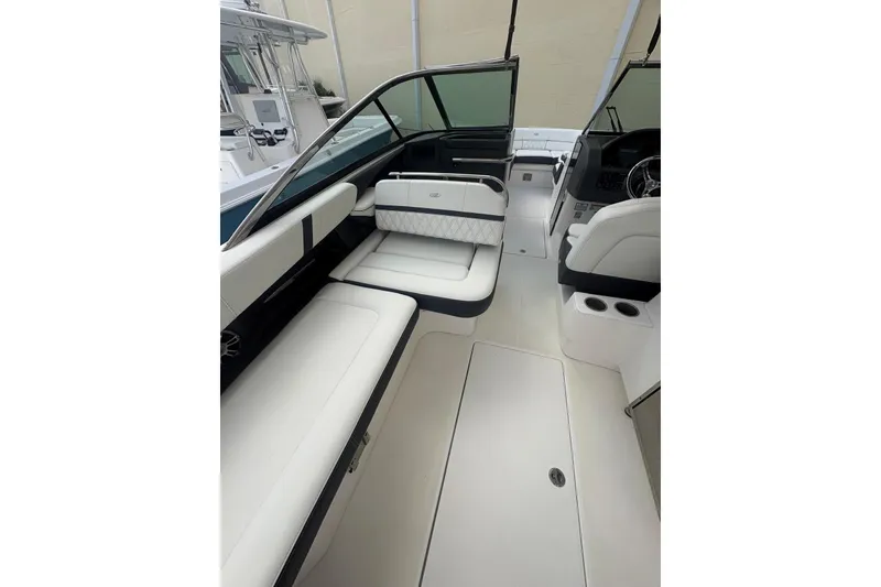 Slide: The Image of 2022 Regal 29 OBX boat interior with white seating and modern dashboard. - 25