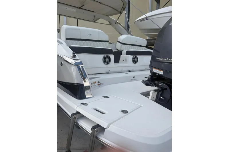 Slide: The Image of 2022 Regal 29 OBX boat with sleek seating and powerful outboard motor. - 28