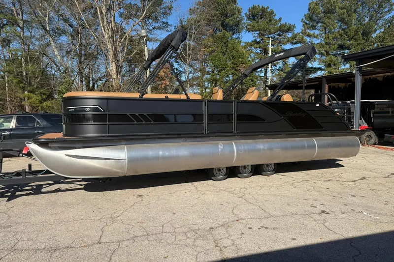 Slide: The Image of 2026 Bentley Pontoons Elite 253 Swingback on a parking lot. - 2