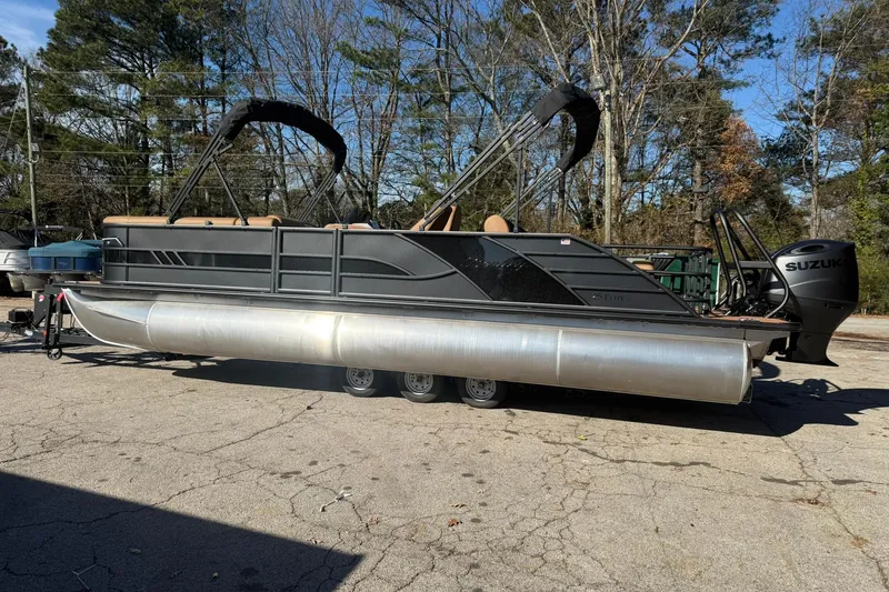 Slide: The Image of 2026 Bentley Pontoons Elite 253 Swingback on a parking lot. - 3