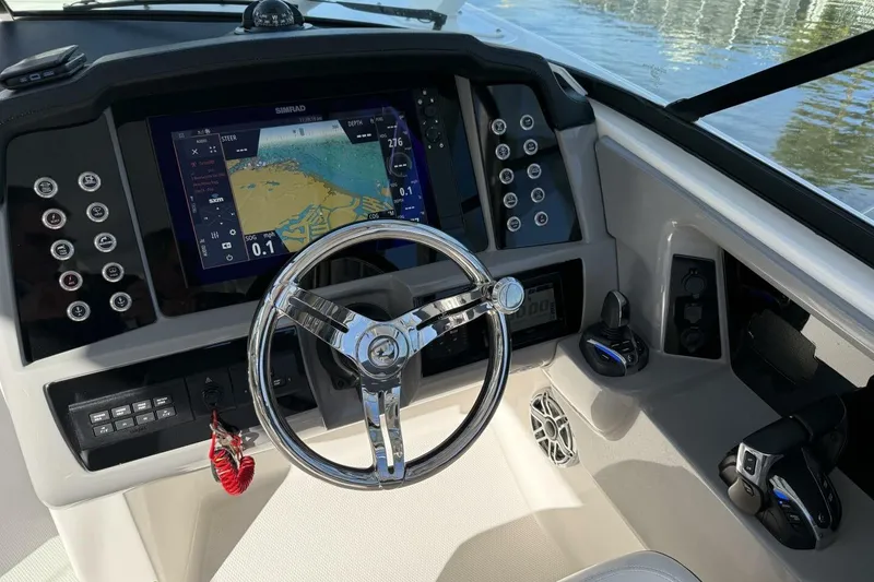 Slide: The Image of 2021 Robalo R317 Dual Console helm with navigation display and controls. - 18